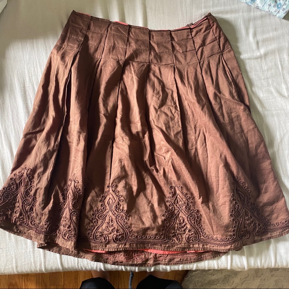 Brown skirt with embroidery designs on the bottom